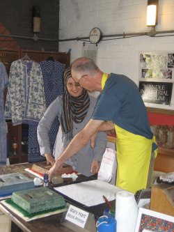 Mick Taylor, showing a member of the Kelmscott House staff how to block print