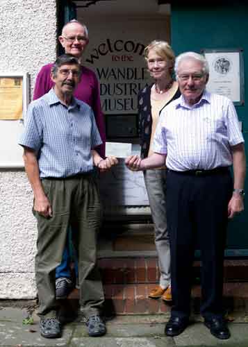 Museum members receiving a cheque