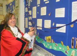 Mayor, Cllr Oonagh Moulton, cutting the ribbon to open the Exhibition